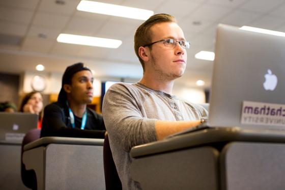 Photo of two Chatham University students paying attention to a lecture